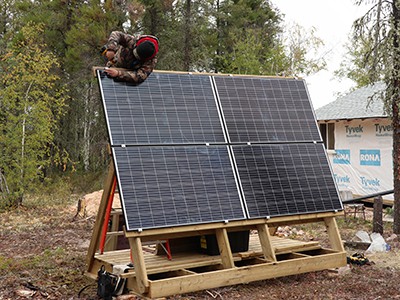 Mason Morley installing cabin solar system